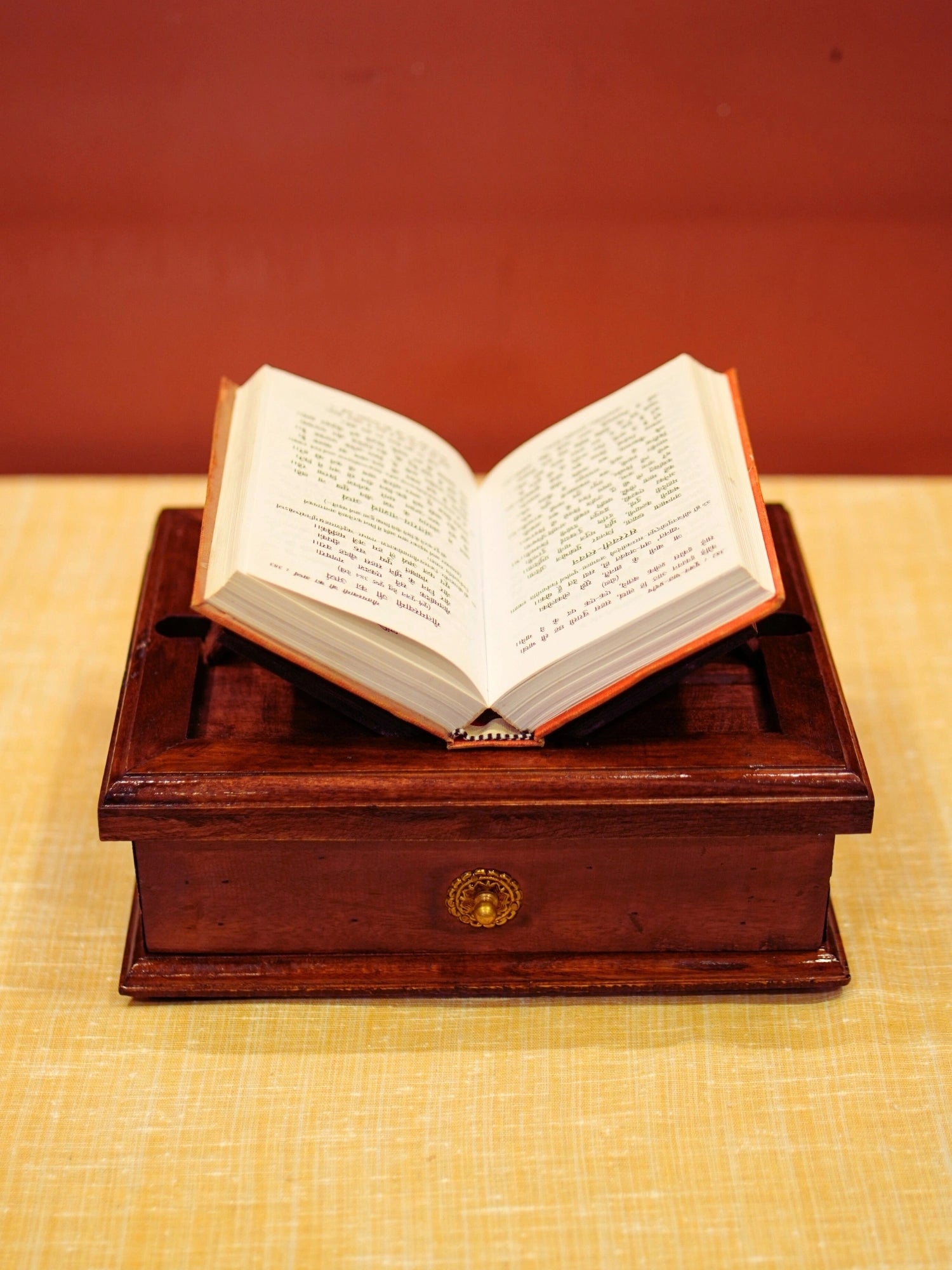 A vintage brown wooden book stand made with wood and brass and a perfect stand to keep a book and keep worship utility