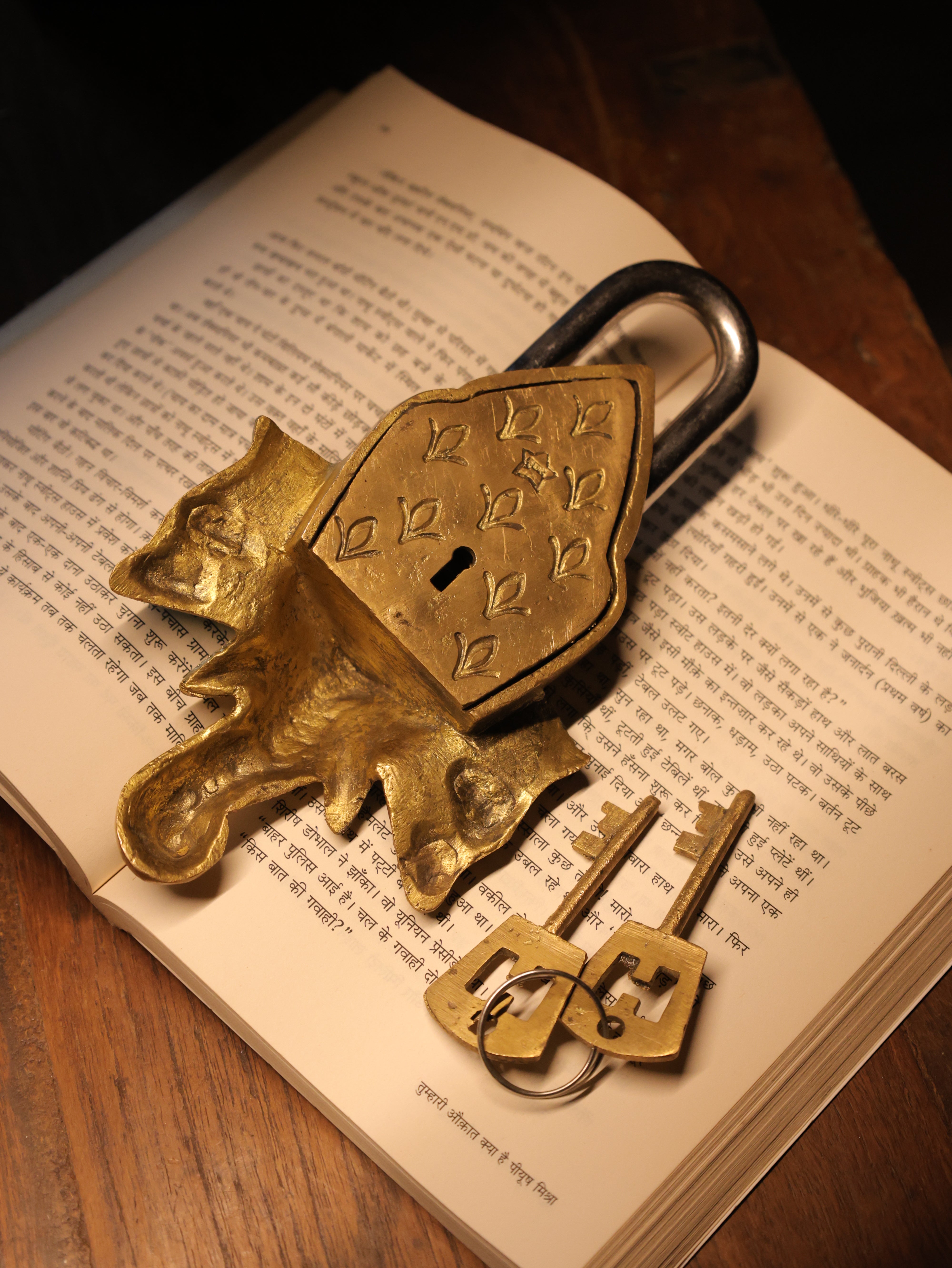 Brass padlock and keys on an open book