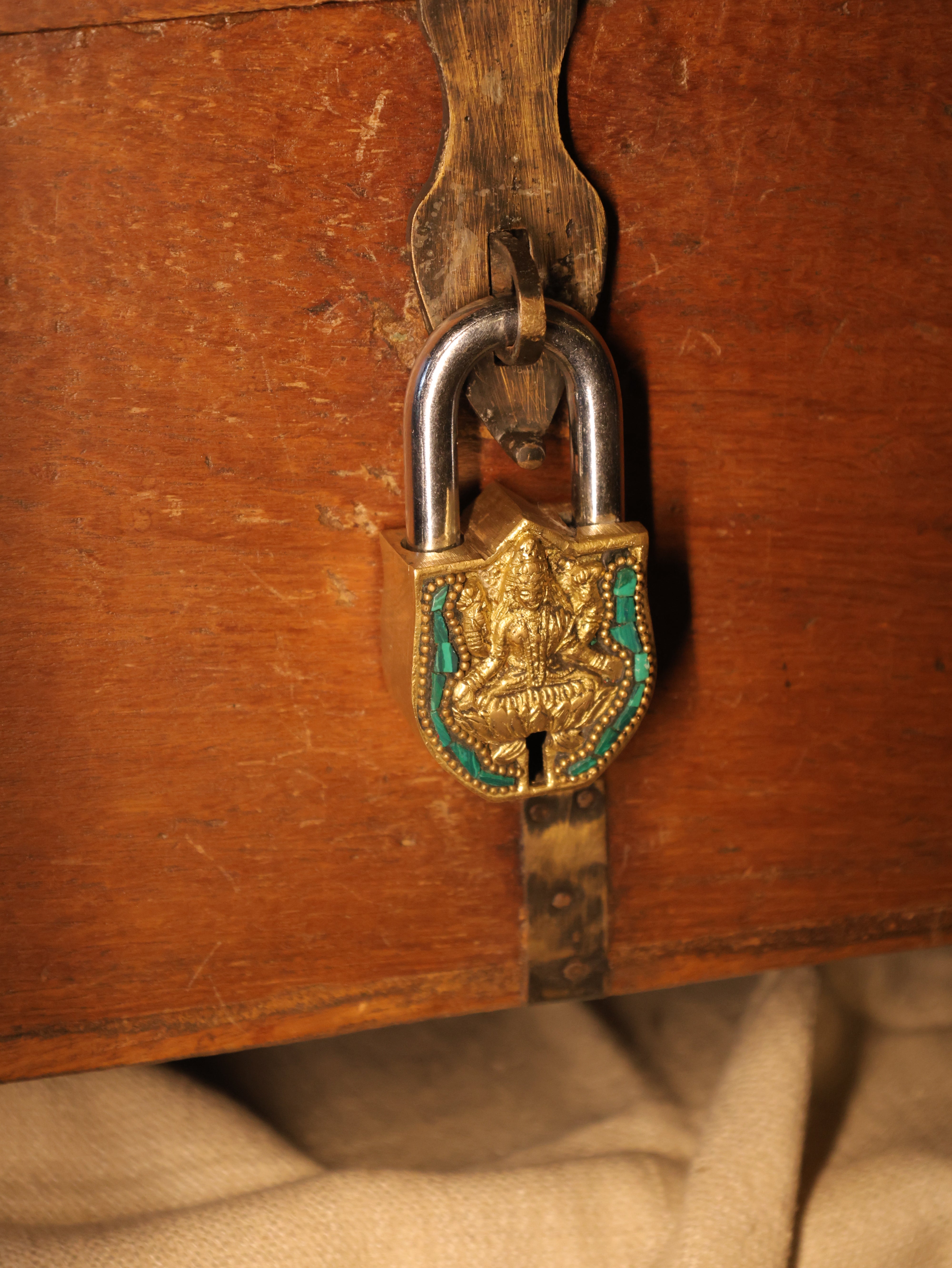 Close-up of a decorative lock on a wooden surface