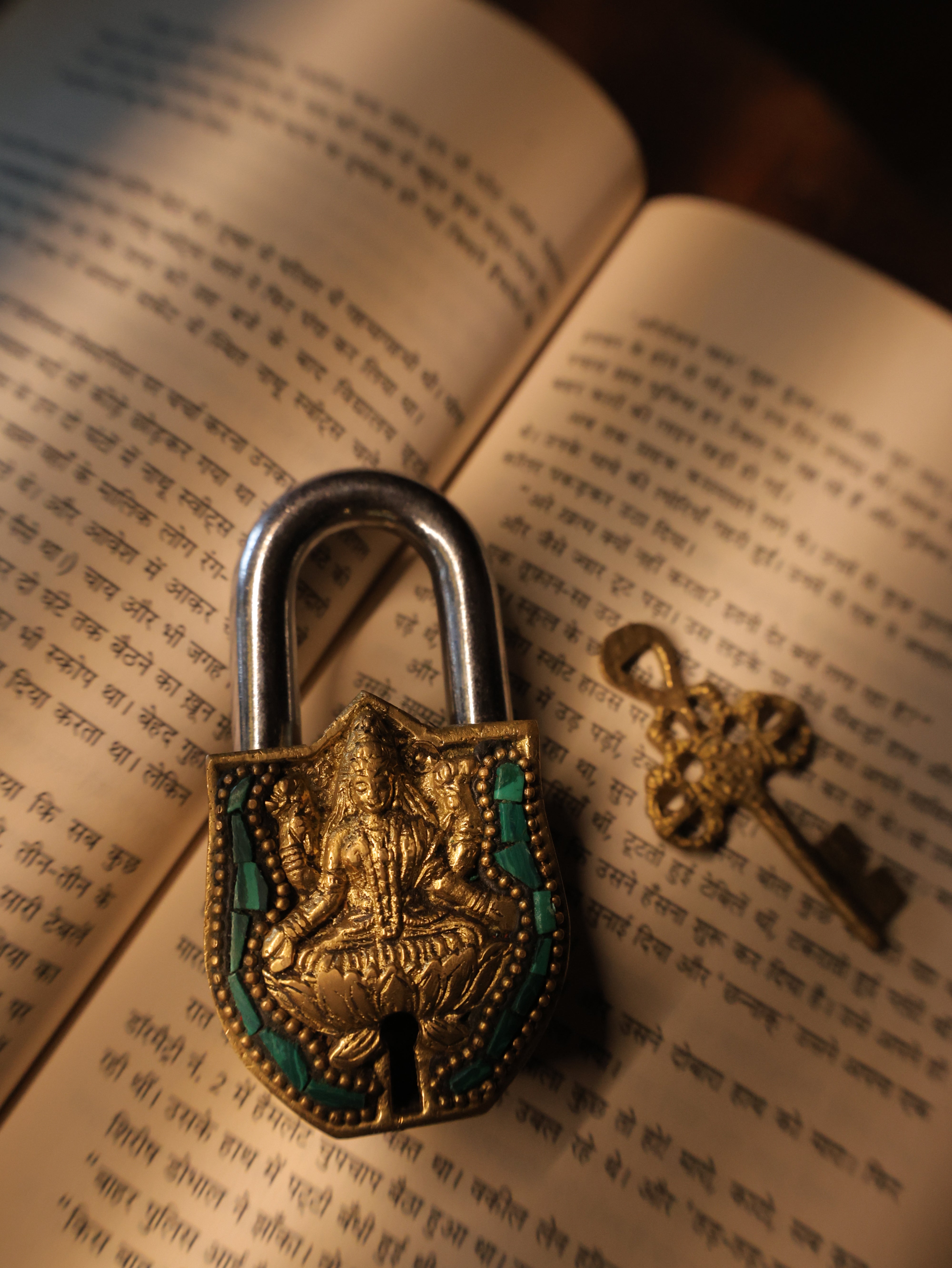 Decorative padlock and key on an open book