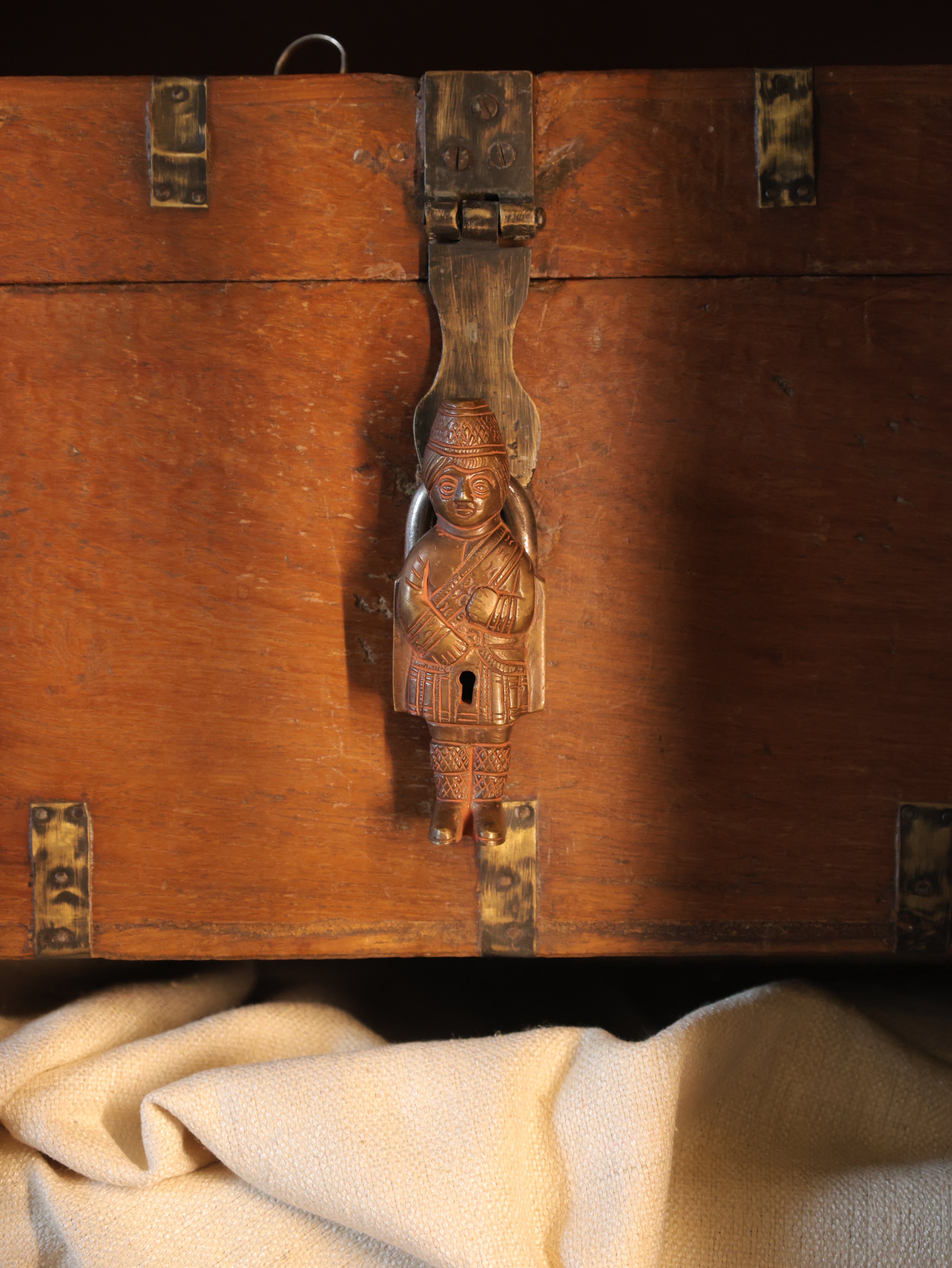 Wooden chest with decorative metal lock and handle