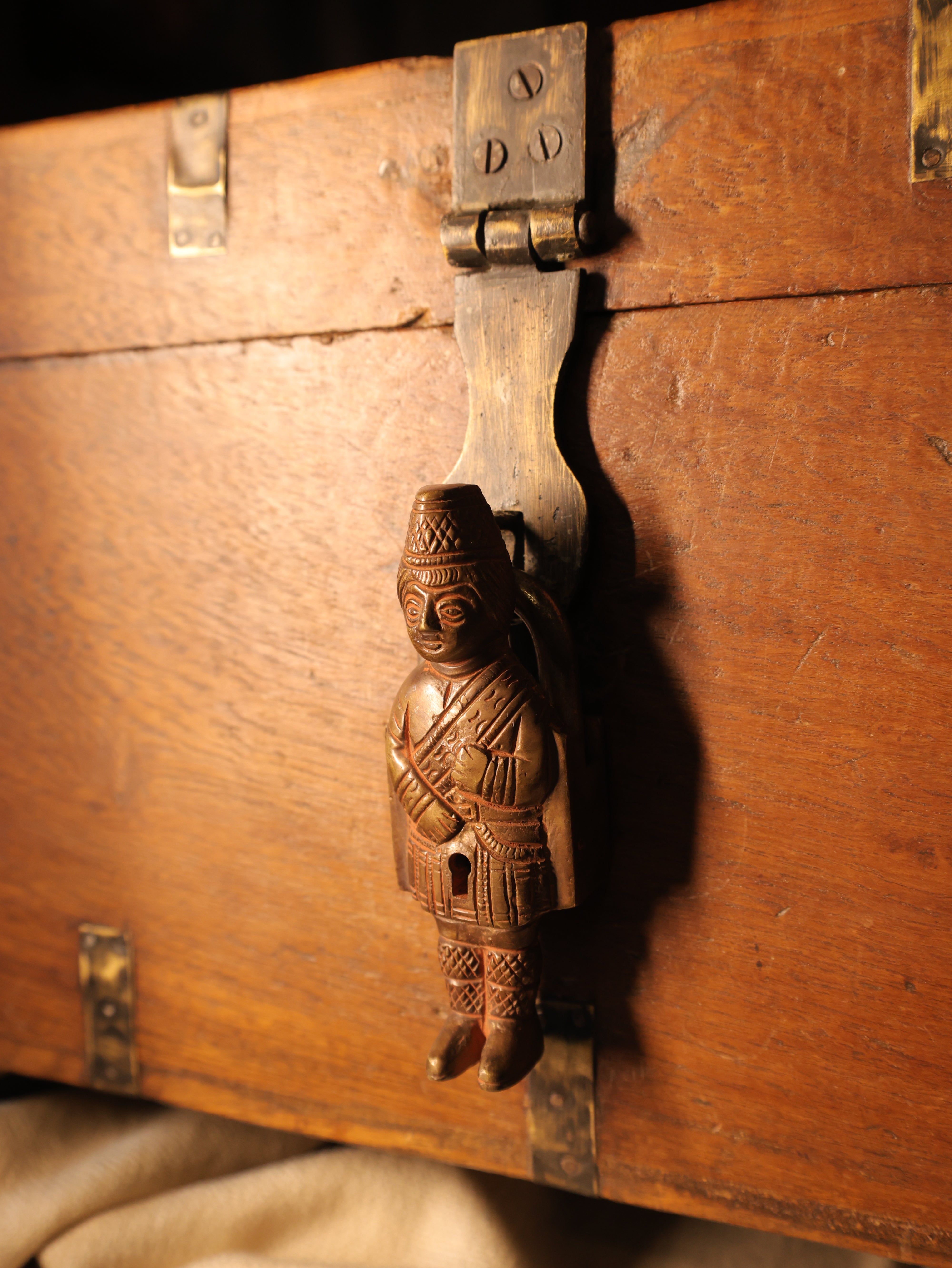Wooden chest with decorative metal lock on a wooden surface