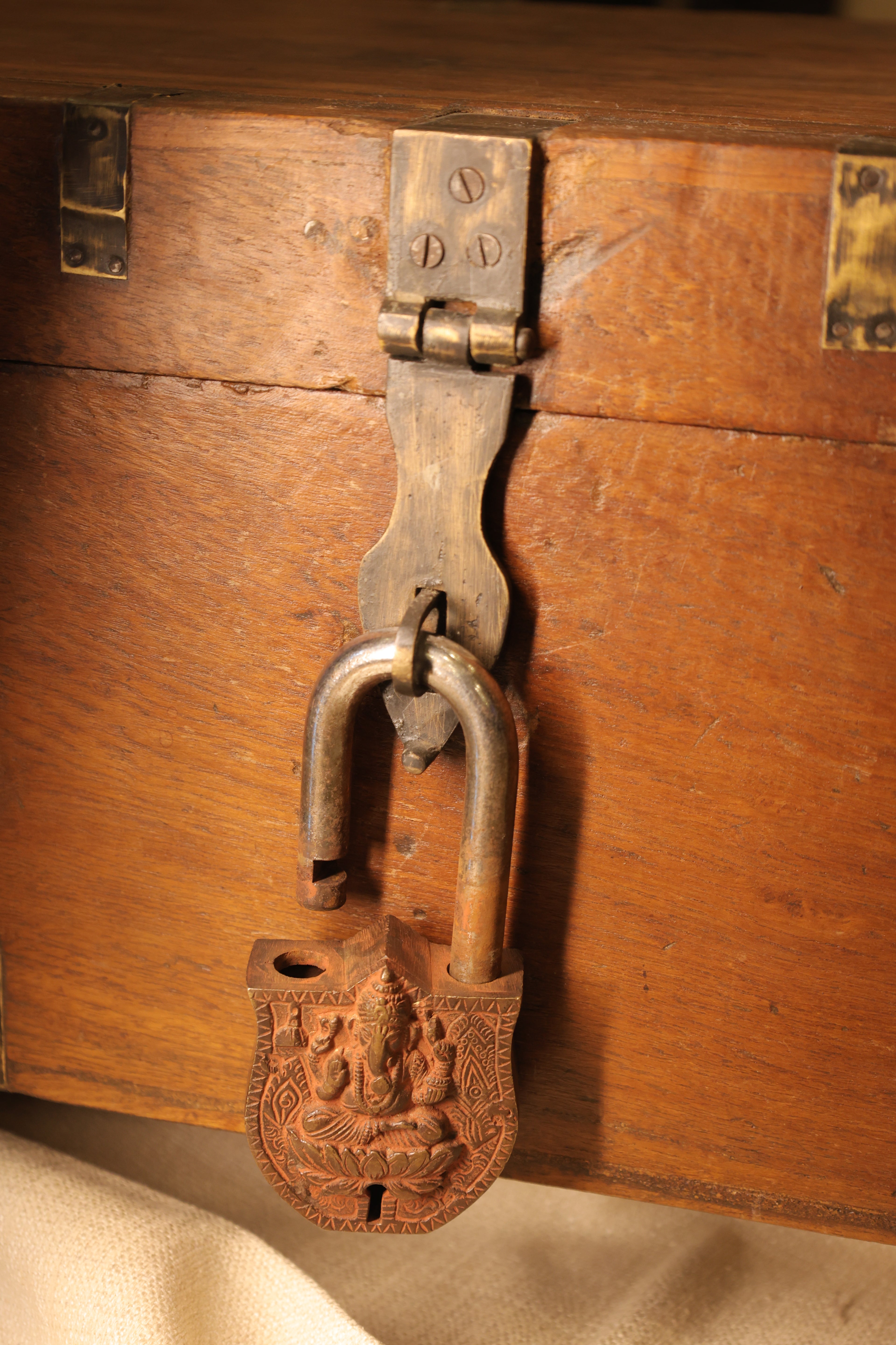 Close-up of a decorative metal lock on a wooden door