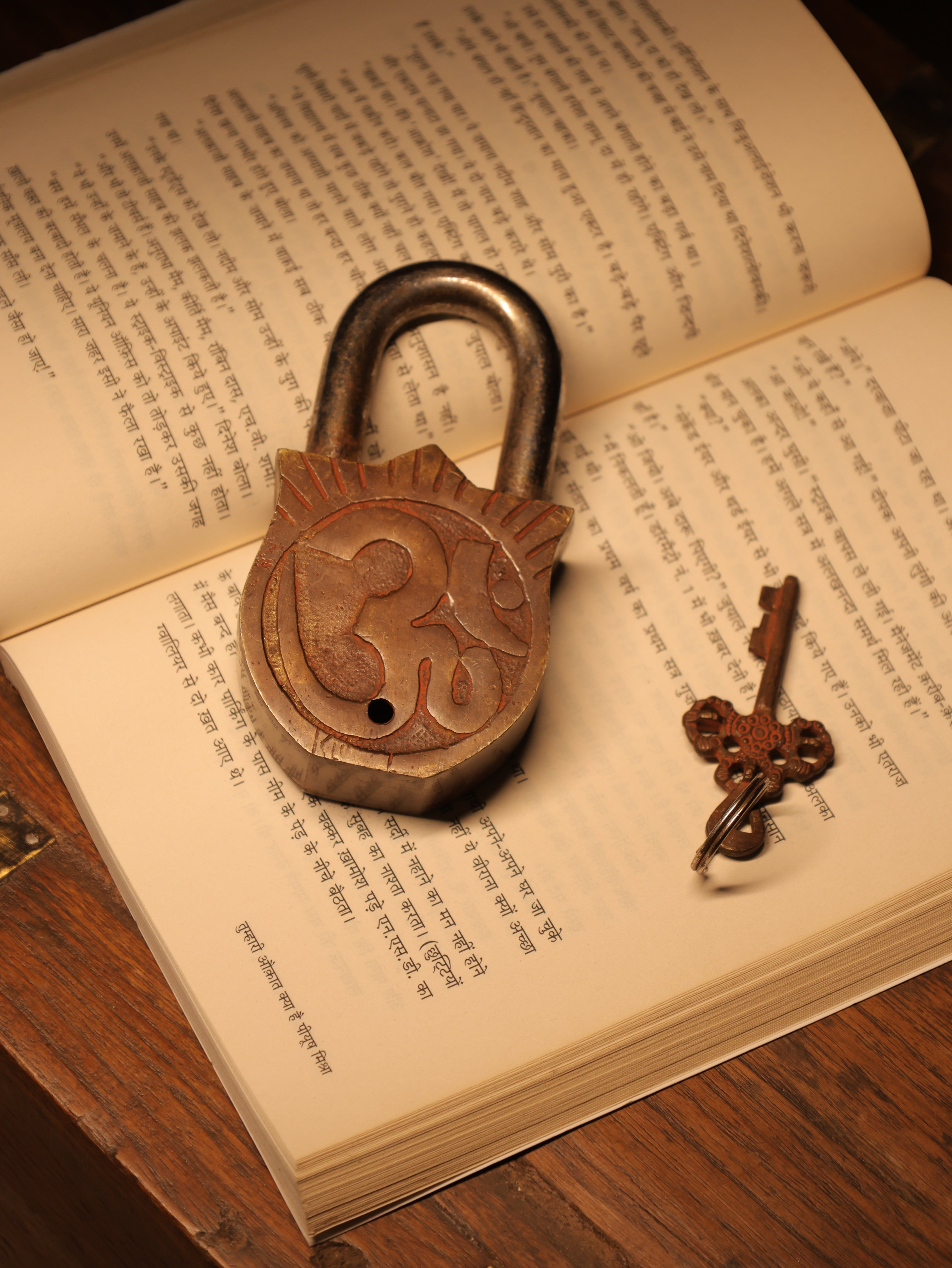Vintage padlock and key on an open book