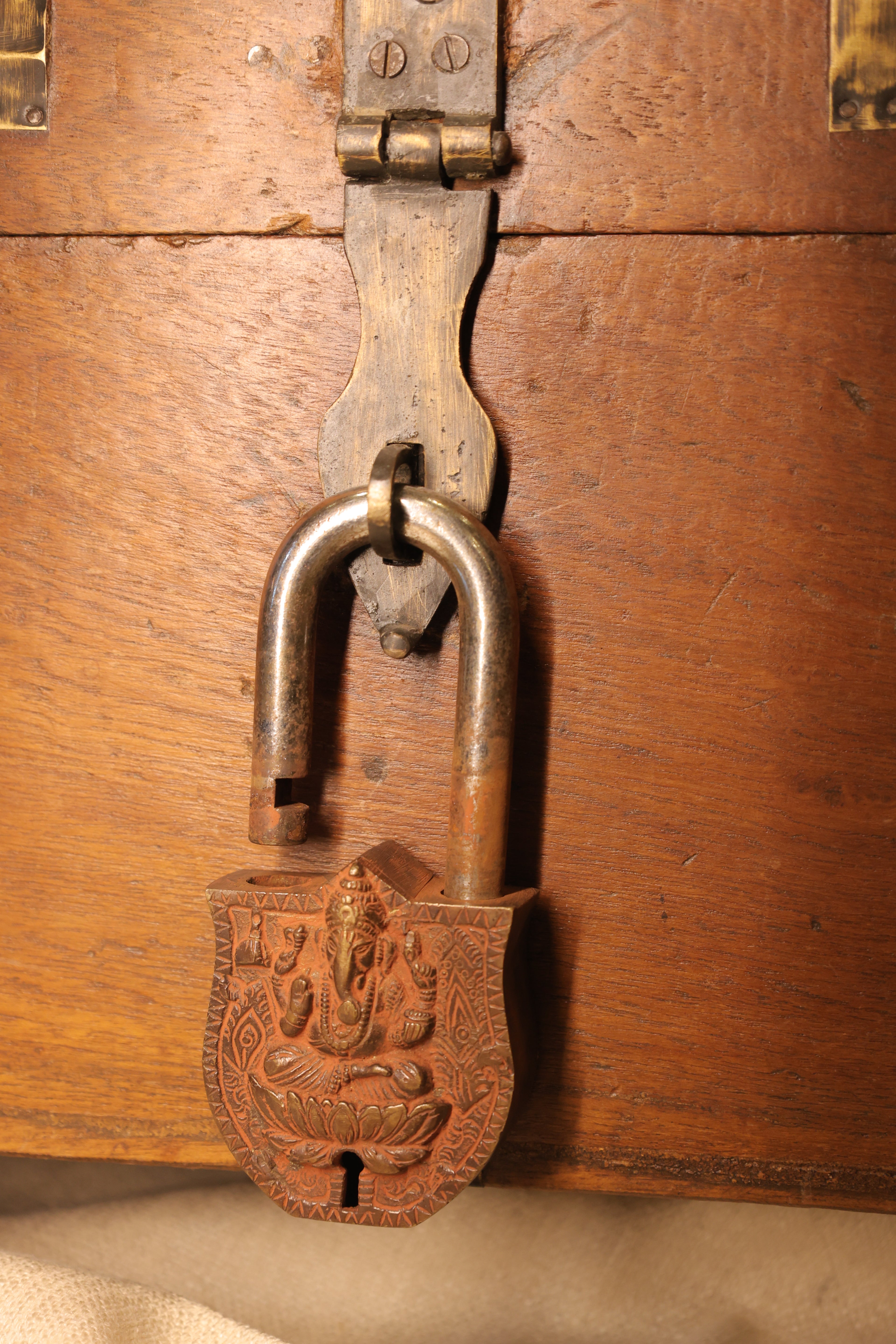 Vintage brass padlock on a wooden surface