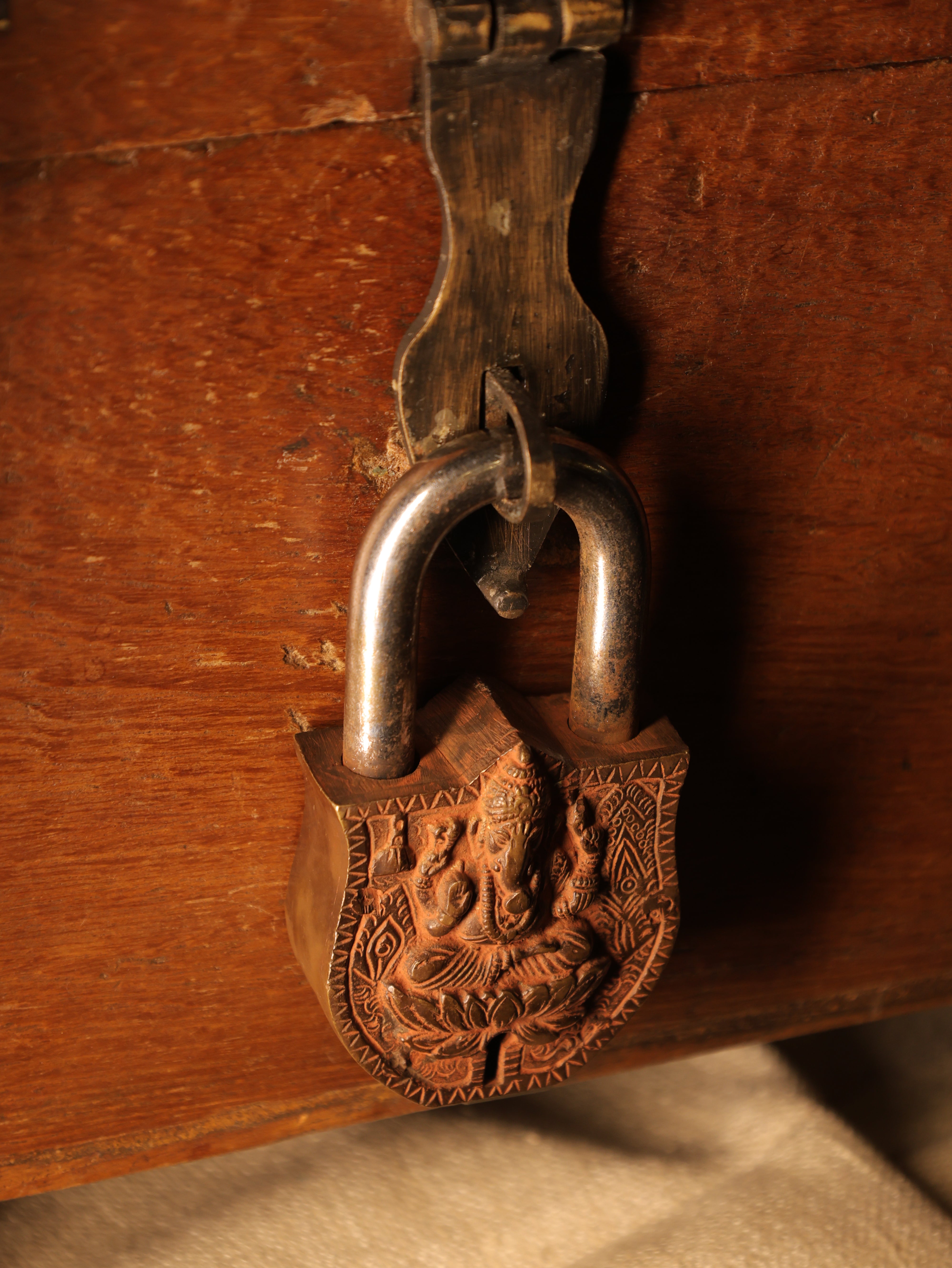 Decorative metal latch on a wooden surface