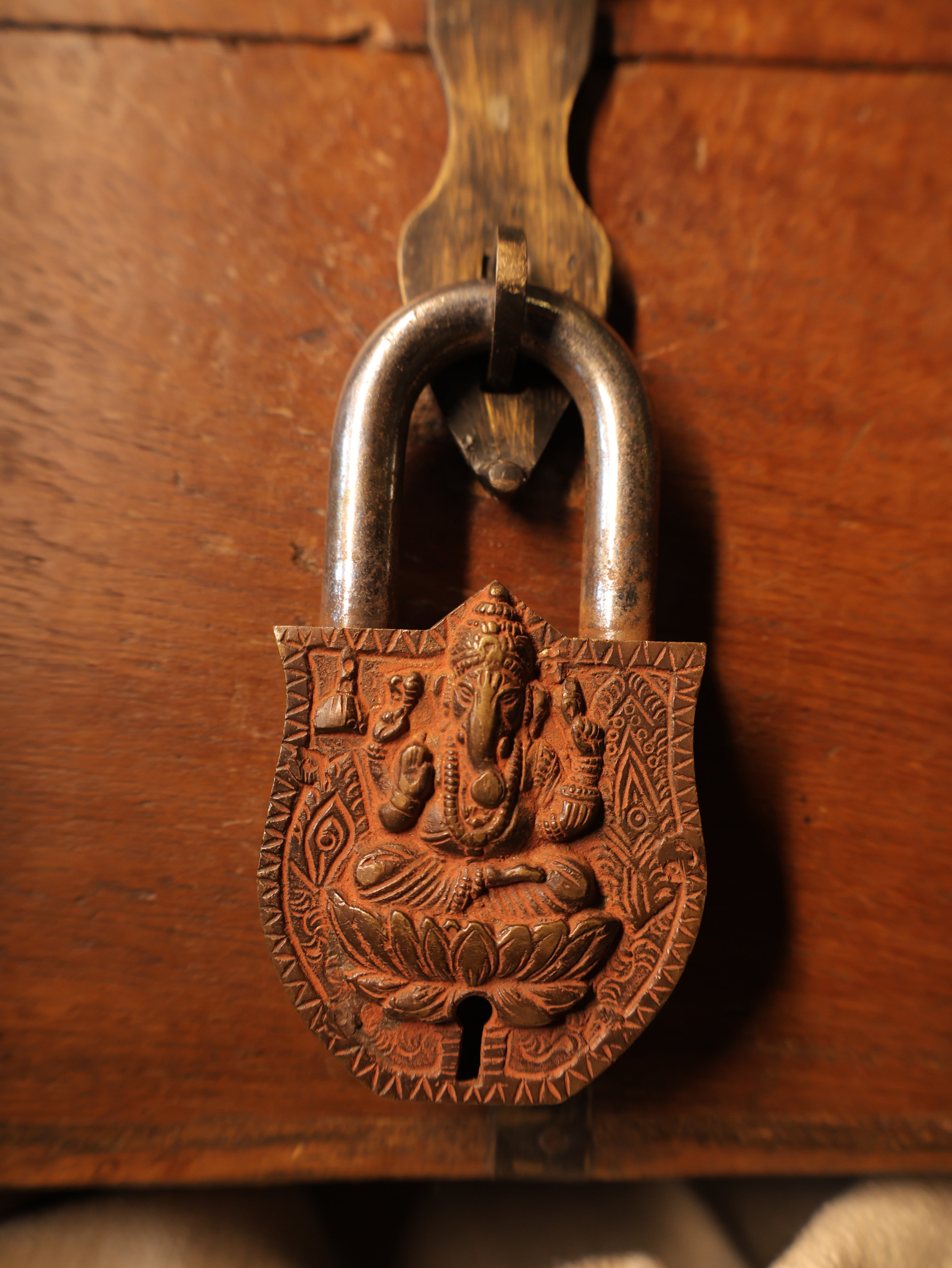Decorative metal lock on a wooden surface