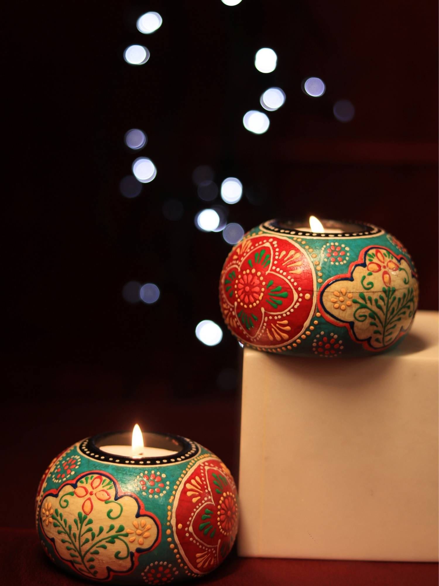 A handpainted wooden tealight holder, a perfect piece to hold a tealight and to add a colour pop to the decor.