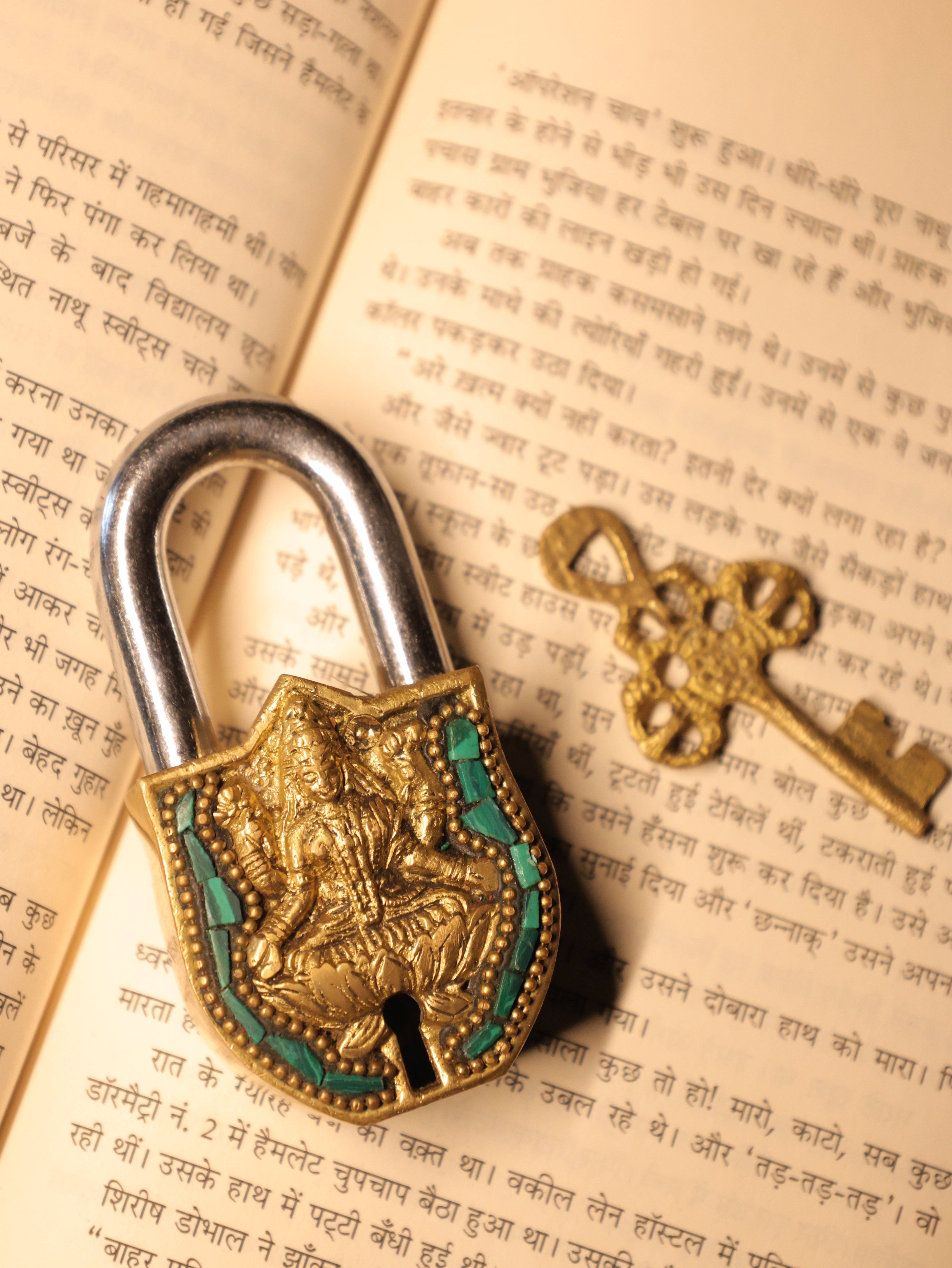 Decorative padlock and key on an open book